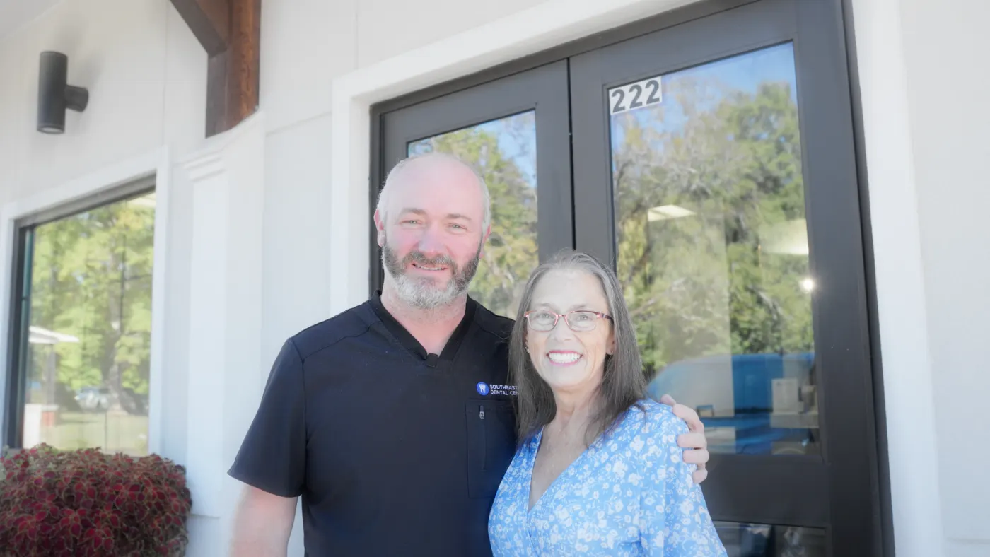 Doctor and smiling patient outside our Hamilton office