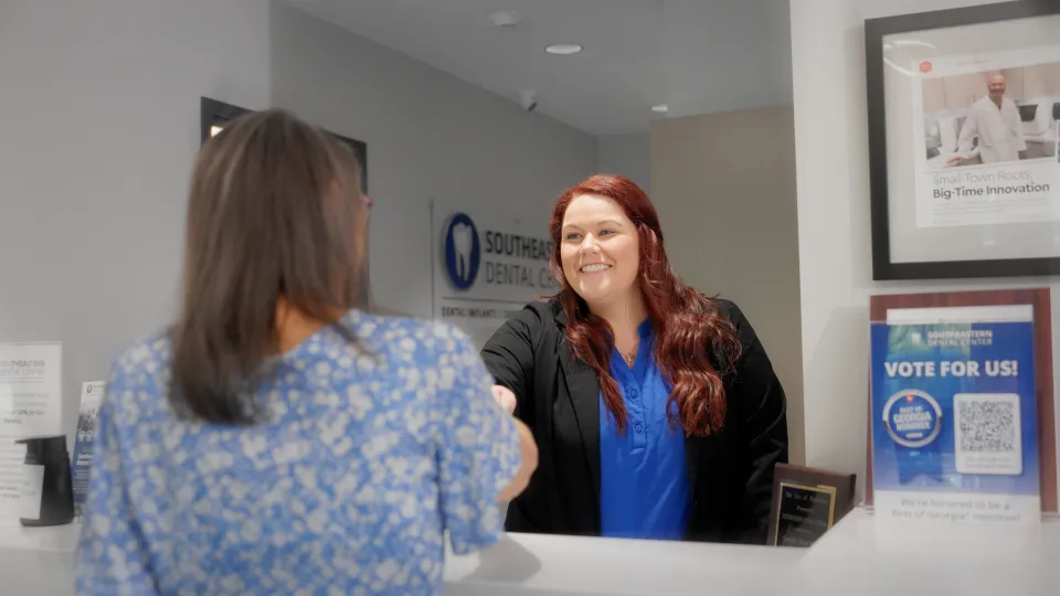 Front desk team member welcoming a patient