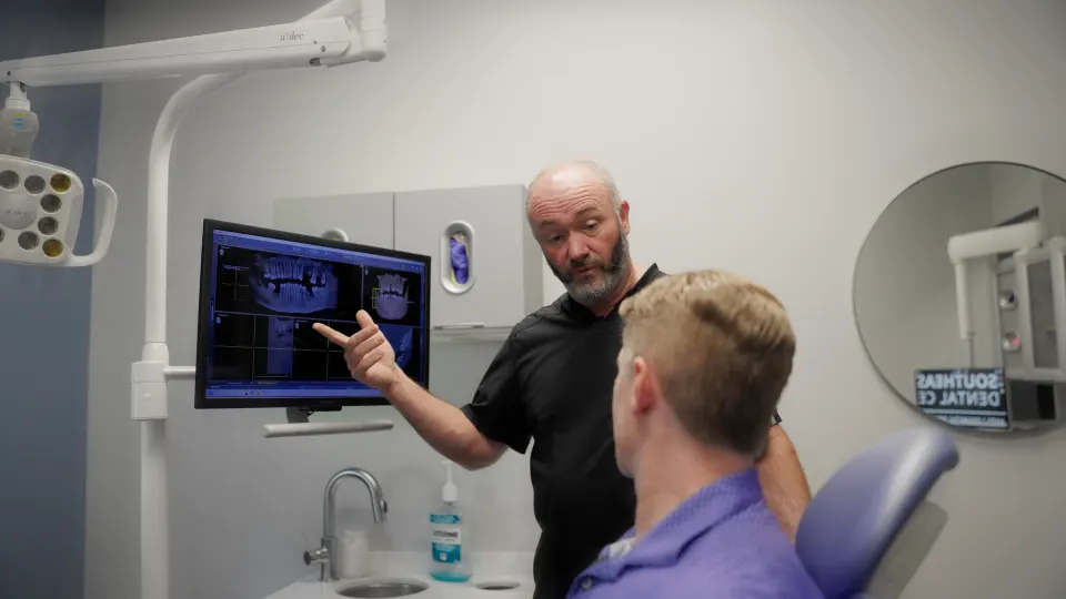 Doctor explaining a digital scan to a patient